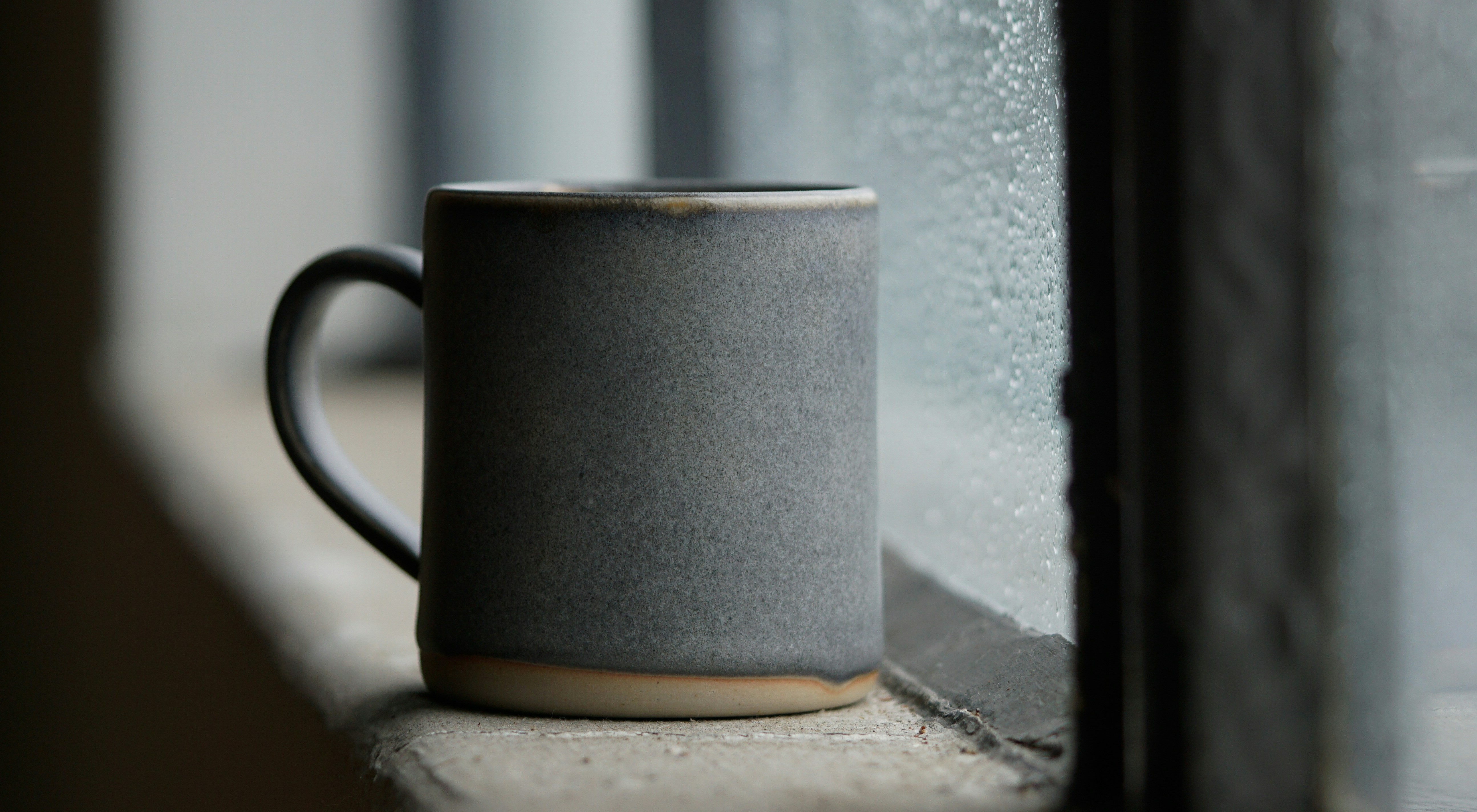 coffee mug next to the window
